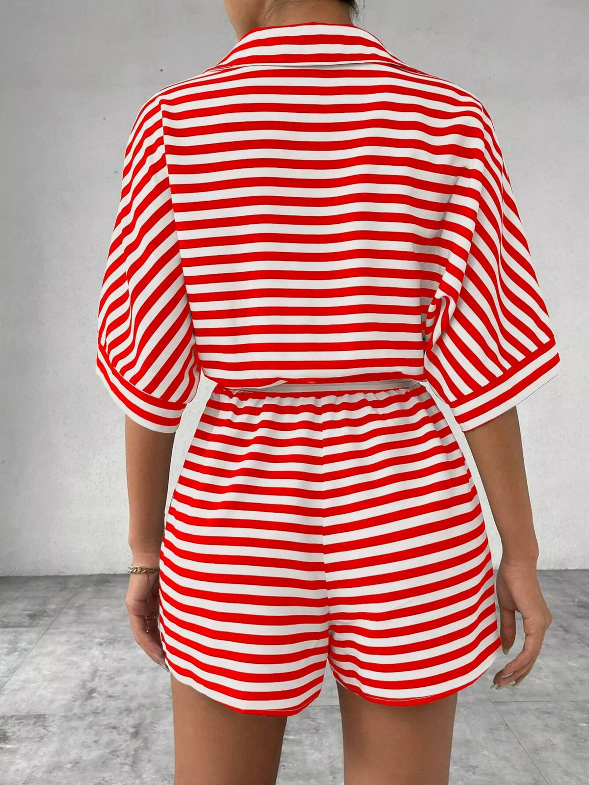 Striped button-front half sleeve romper shirt by Plush Fashion Hub, featuring a casual design with a front button closure.