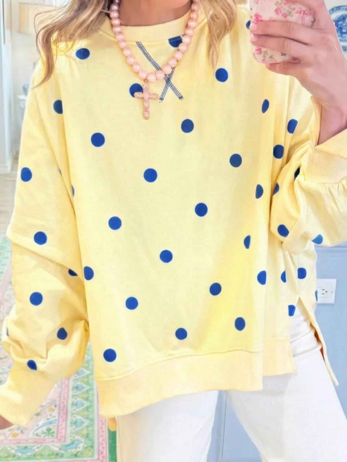 Polka dot oversized sweatshirt with side slit from Trendsi, featuring a relaxed fit and casual style in soft fabric.