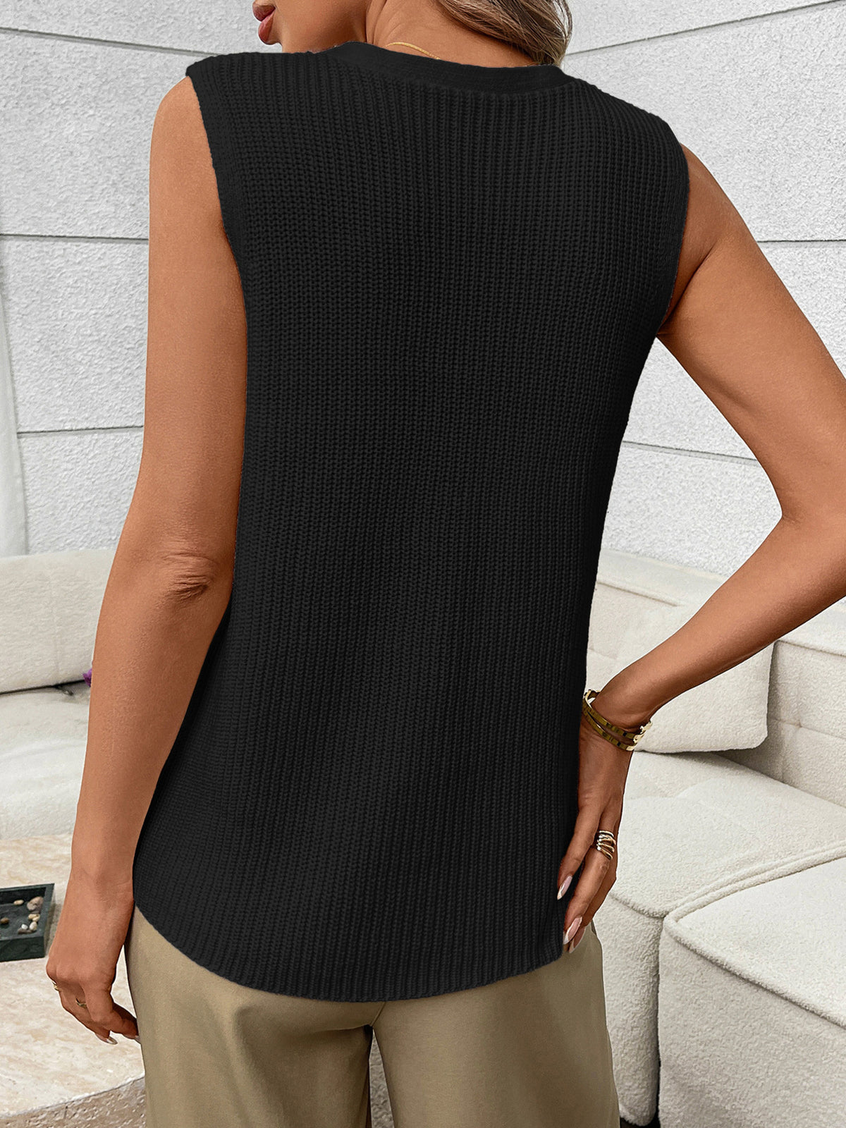 Women's sleeveless knit sweater vest with buttons and side pockets by Plush Fashion Hub, shown in a stylish, close-up view.