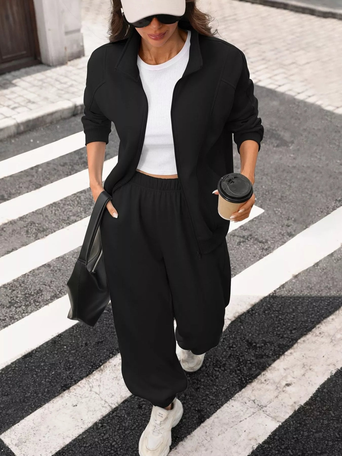 Women's zip-up long sleeve top and matching pants set by Trendsi, casual loungewear with comfortable fit and stylish design.