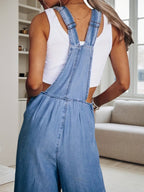 Women’s wide leg denim overalls by FitiqueFit featuring casual style, adjustable straps, and a relaxed fit on a plain background.