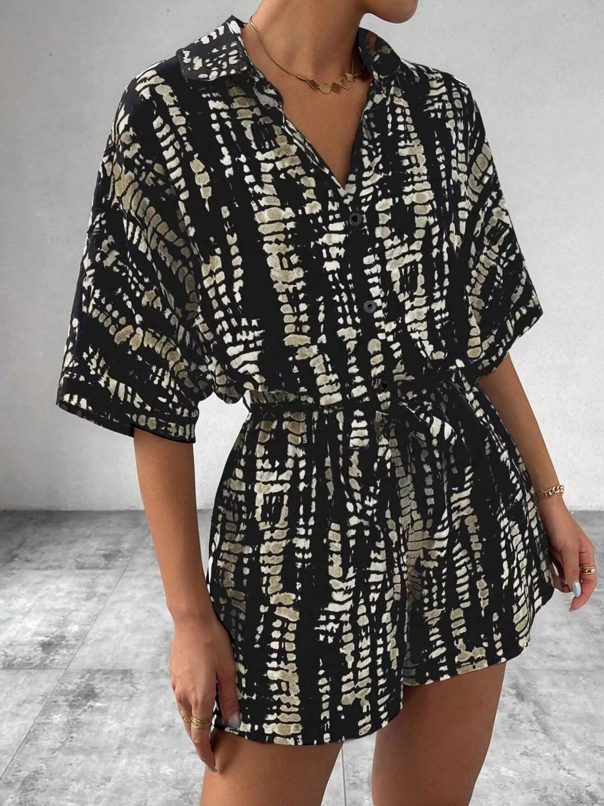 Striped button-up belted romper jumpsuit by Plush Fashion Hub, showing front view with collar and waist tie.