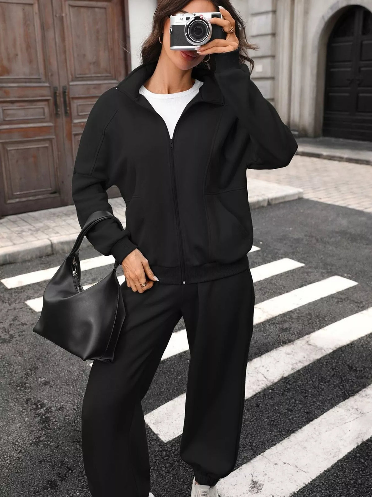 Women's zip-up long sleeve top and pants set by Trendsi, casual loungewear with comfortable fabric and stylish fit.