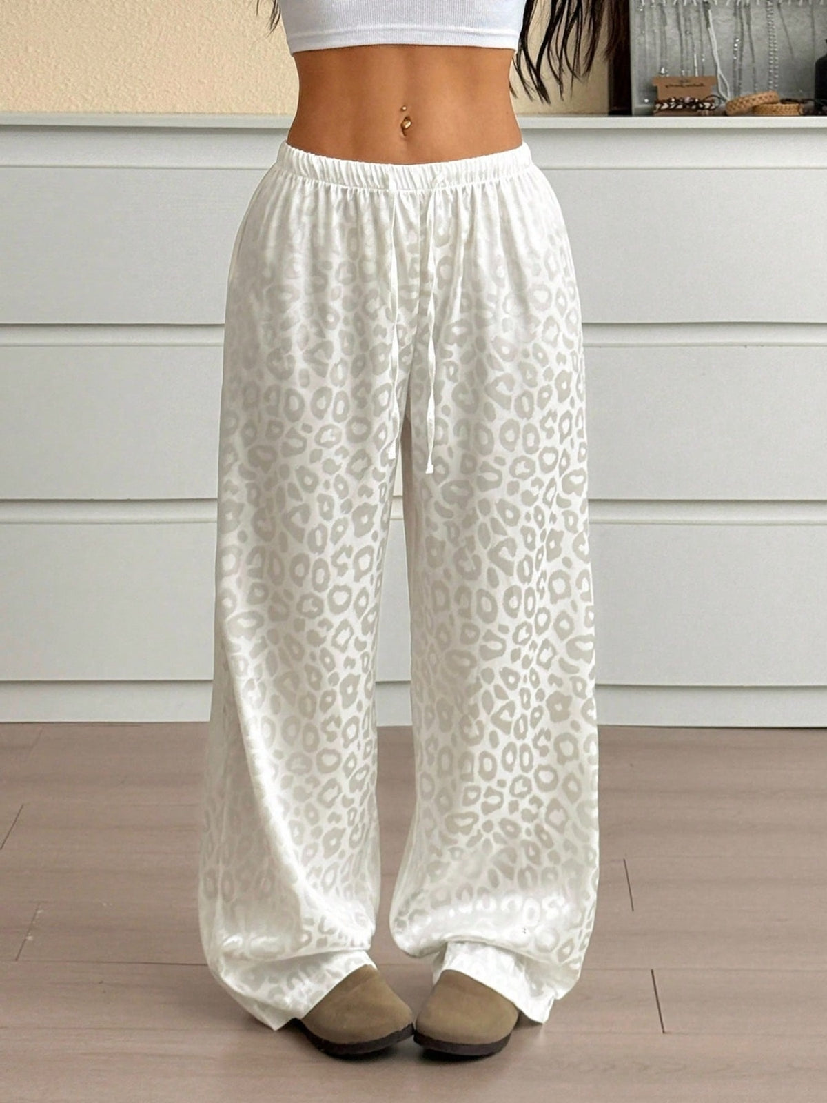Women’s leopard print wide leg trousers with adjustable drawstring waist, stylish pants from Plush Fashion Hub.