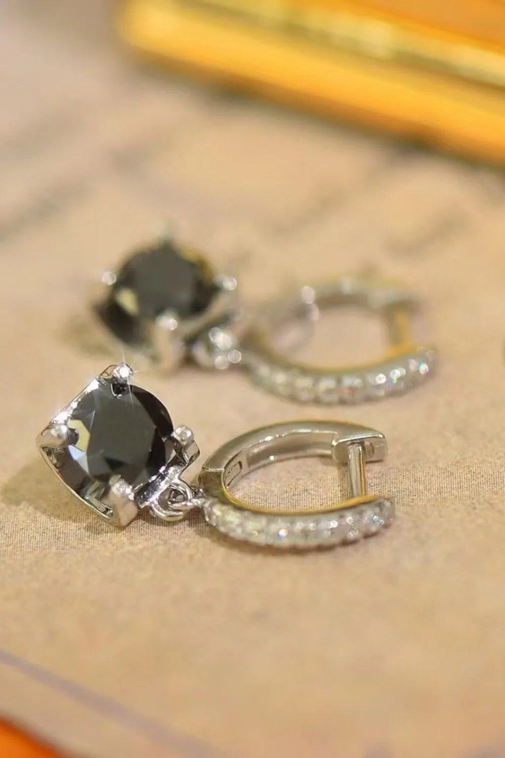 Sterling silver 2 carat moissanite drop earrings with elegant design, shiny gemstones, and polished silver finish.