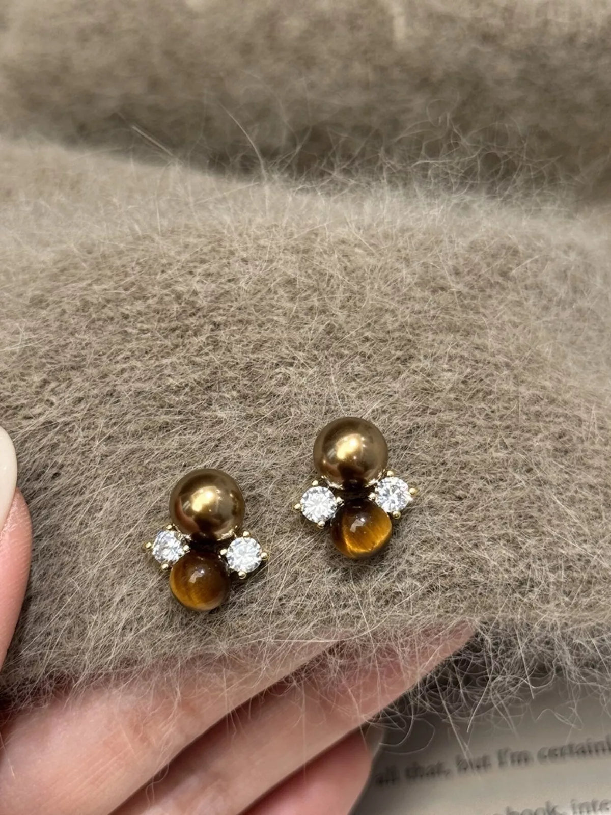 Plush Fashion Hub tiger eye stud earrings featuring polished, oval-shaped gemstone earrings on a white background.