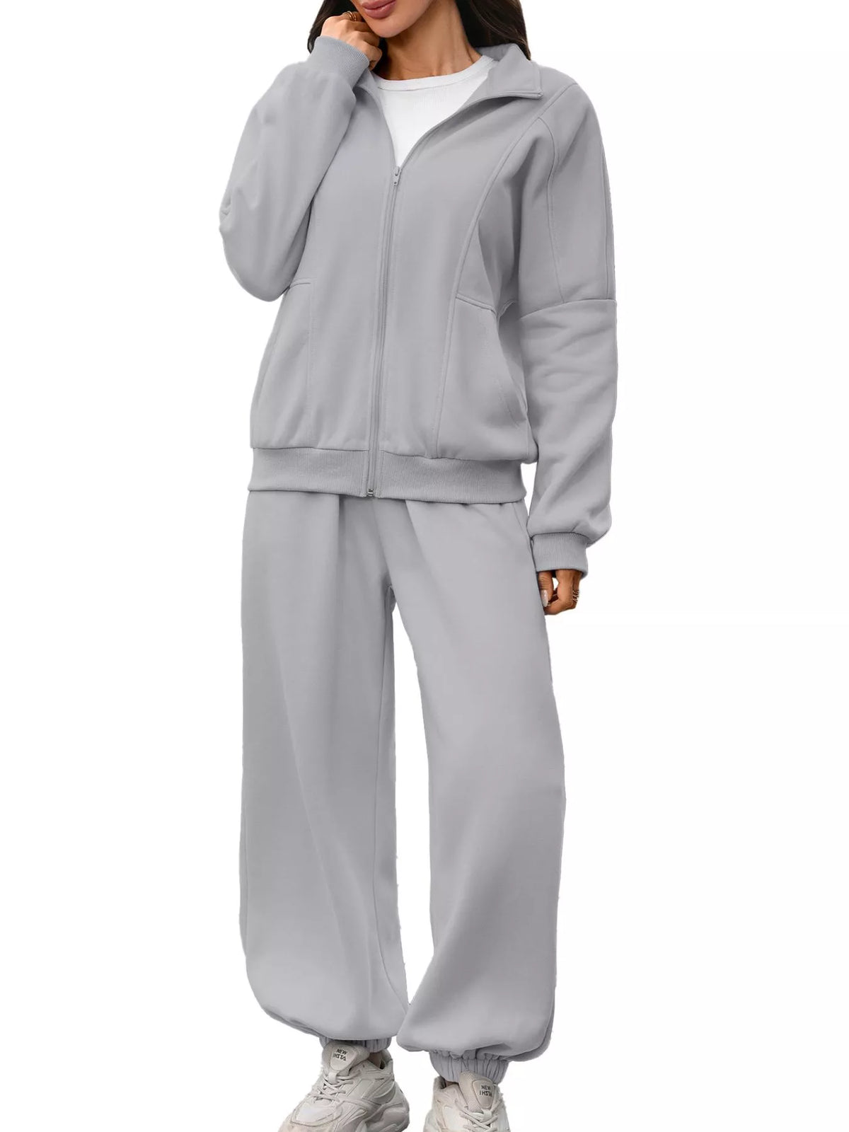 Women's zip-up long sleeve top and pants set by Trendsi, featuring a comfortable, casual athletic outfit in matching fabric.