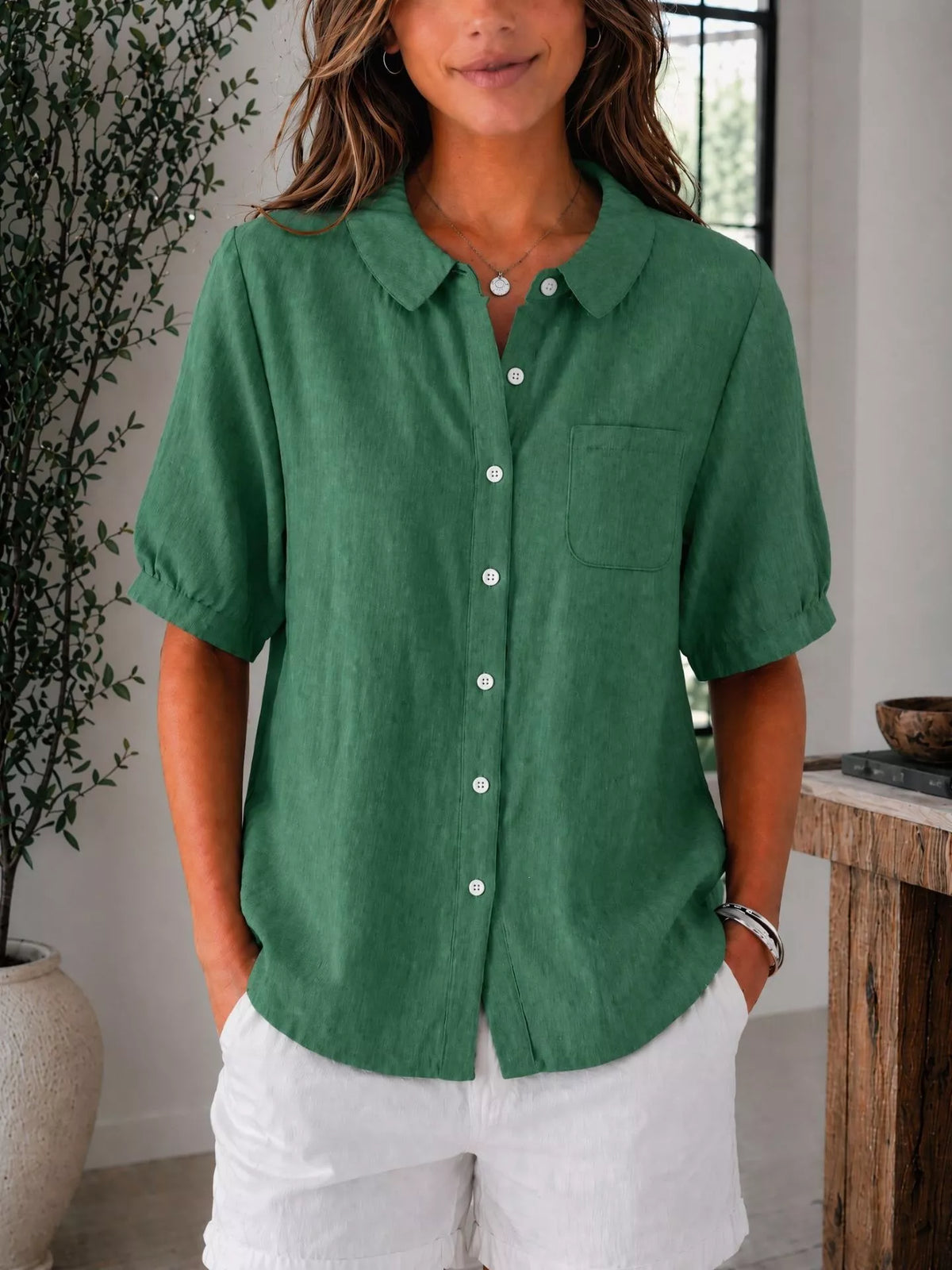Plus size short sleeve button-up shirt from Trendsi, casual tops with a relaxed fit and classic collar, shown on a hanger.
