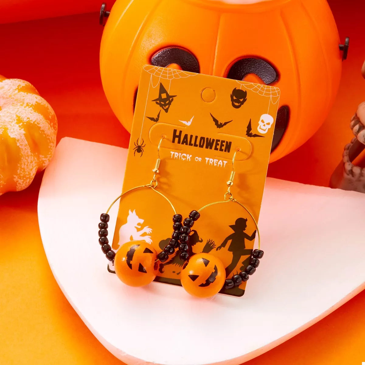 Gold-plated Halloween bead earrings by Plush Fashion Hub featuring festive orange and black beads on silver hooks.