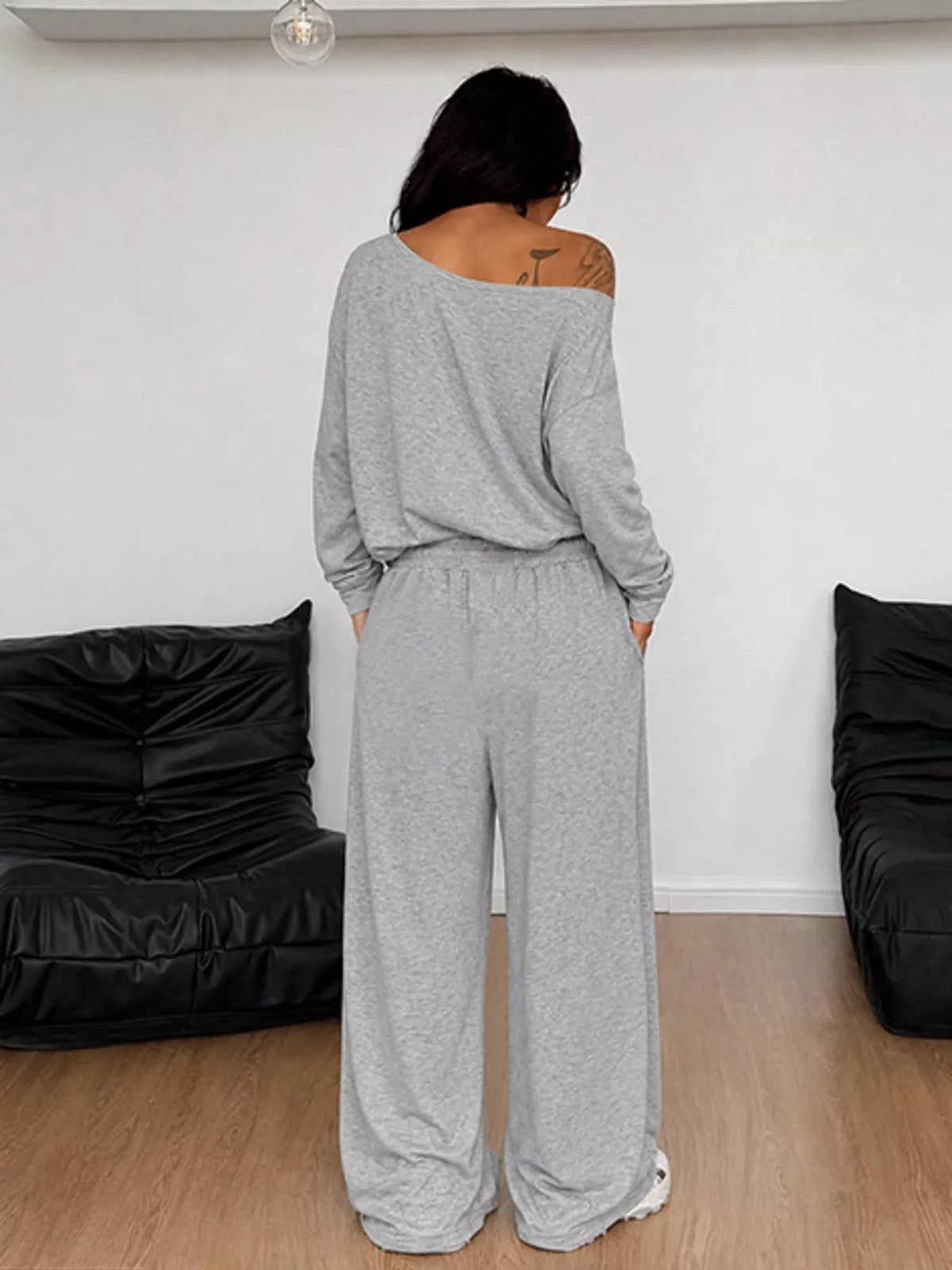 Plus size loose fit one-shoulder T-shirt and matching pants set by Trendsi, casual and comfortable fashion ensemble.