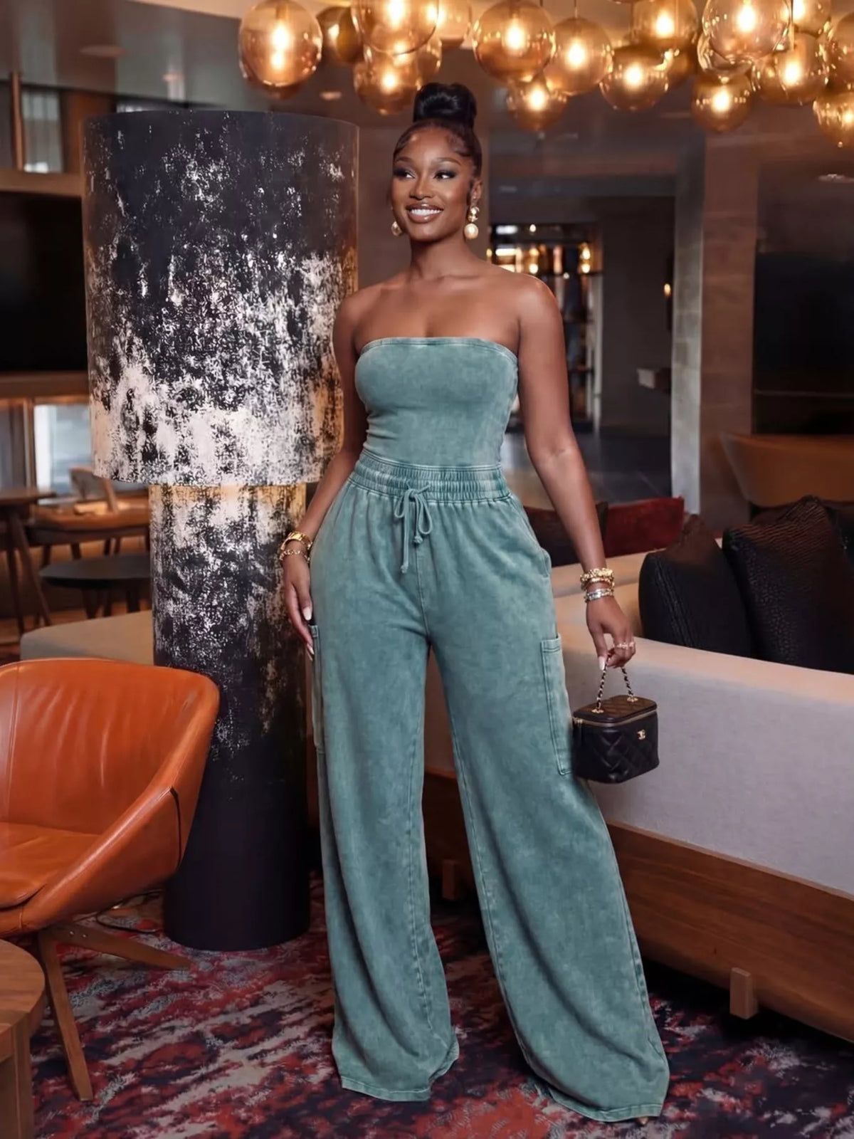 Strands, strapless wide-leg jumpsuit by Trendsi with drawstring waist, flowing fabric, and relaxed fit.