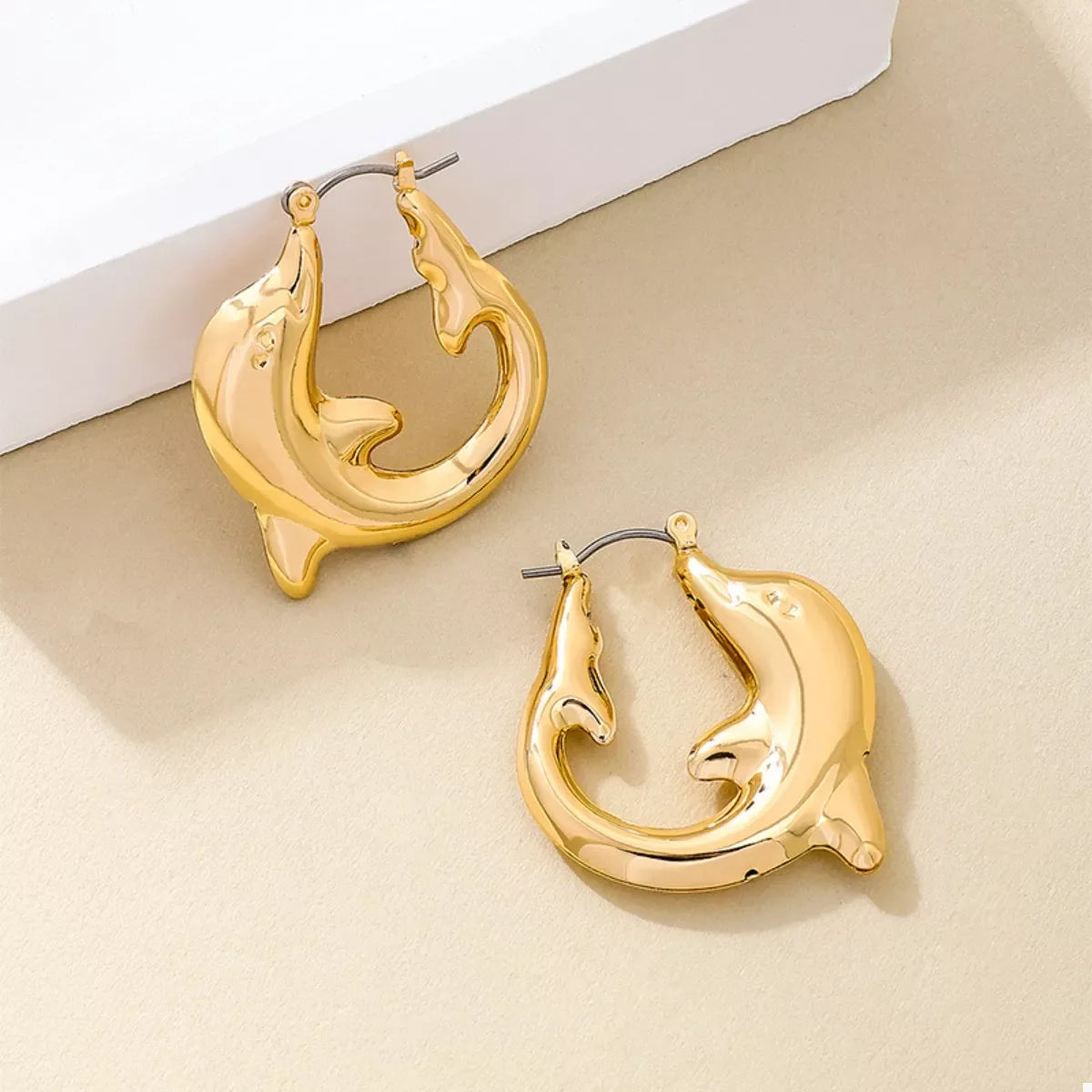 18K gold-plated dolphin hoop earrings with a sleek, shiny finish, featuring detailed dolphin designs, perfect for stylish accessories.