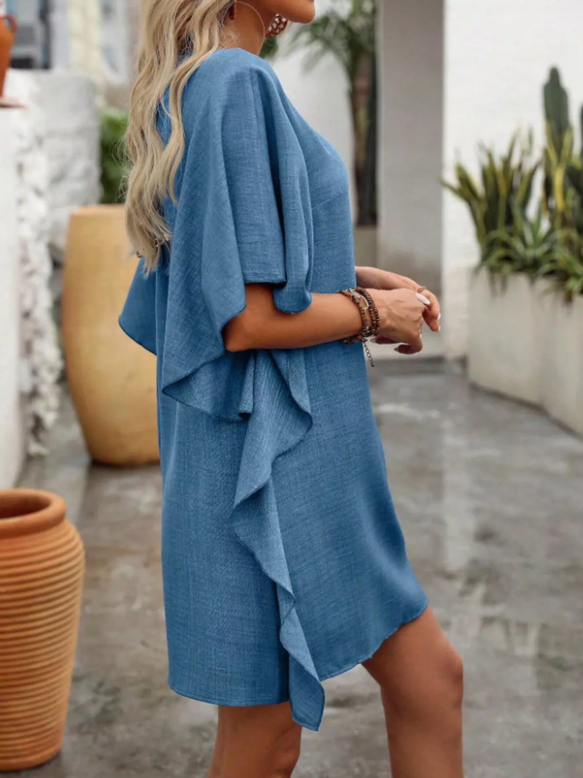 Women’s flowy V-neck casual mini dress with ruffled sleeves by Plush Fashion Hub, featuring a relaxed fit and feminine design.