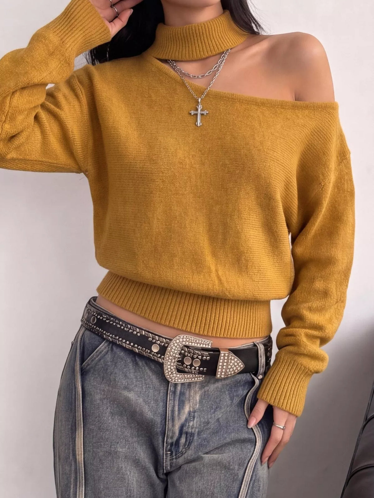 Cold-shoulder dropped shoulder sweater by Trendsi, featuring a cozy knit design with cut-out shoulders and relaxed fit.