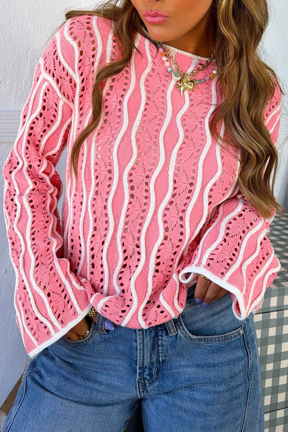 Wavy detail hollow-out knit long sleeve sweater for women by Trendsi, featuring a textured wavy pattern and open-knit design.