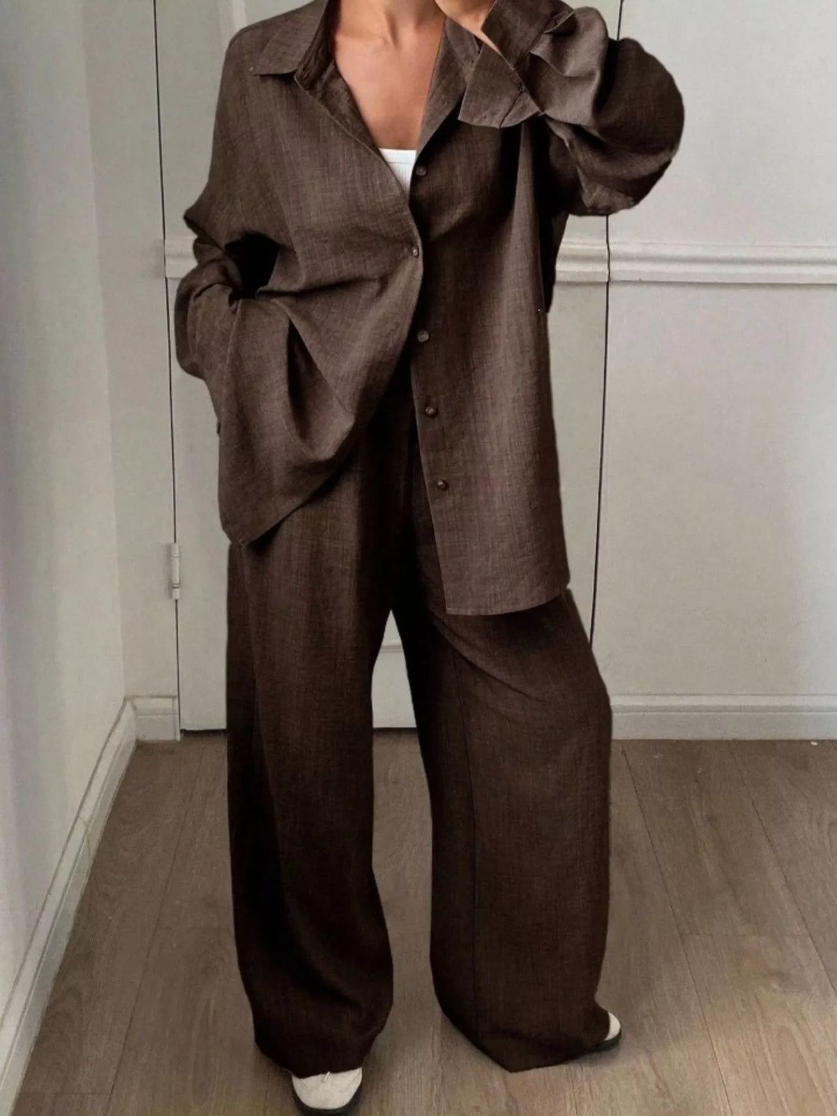 Trendsi long sleeve button-up shirt and wide-leg pants set, stylish and comfortable, shown in a coordinated outfit.