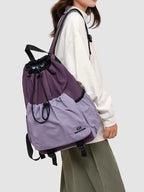 Lightweight nylon drawstring backpack by Trendsi, minimalist travel bag for women, showing the black nylon material and drawstring closure.