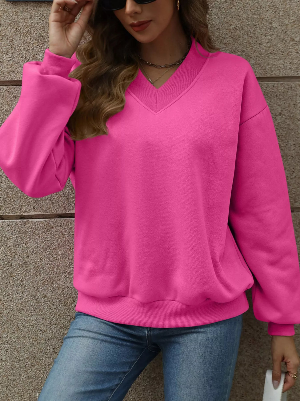 V-neck solid color casual sweatshirt by Trendsi, featuring a relaxed fit, long sleeves, and a comfortable neckline.