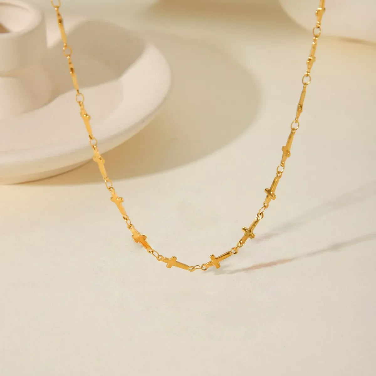 18K gold-plated cross necklace with delicate chain from Plush Fashion Hub, displayed against a neutral background.
