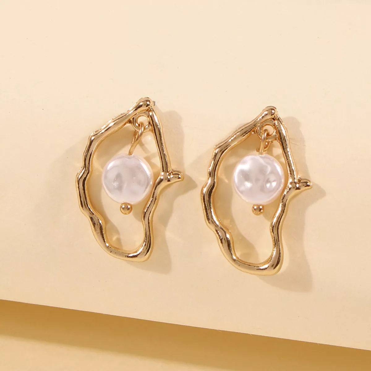 Elegant 18K gold-plated pearl earrings featuring lustrous pearls and a sleek design, perfect for sophisticated accessories.