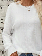 Textured round neck long sleeve T-shirt by Trendsi, showing close-up of fabric detail and classic fit in a natural pose.