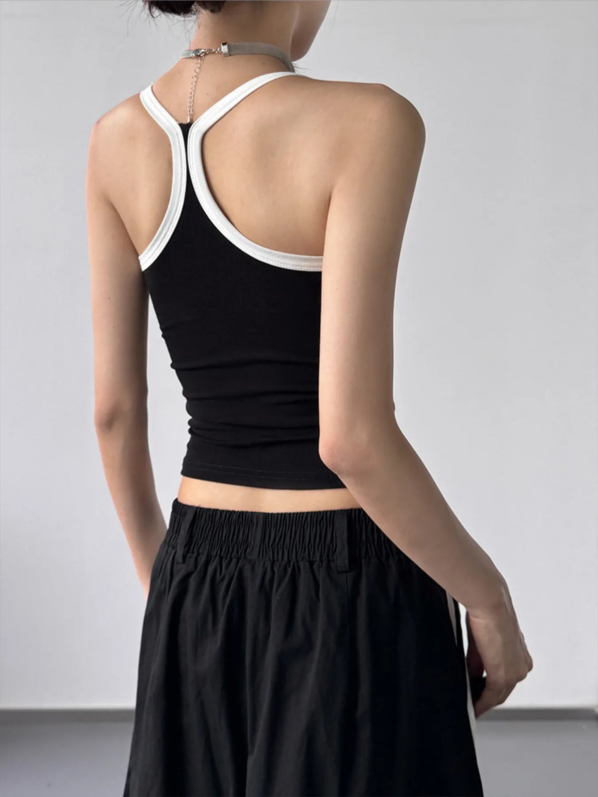 Black contrast trim cami top from Plush Fashion Hub featuring thin straps and a fitted design, ideal for casual and layered looks.