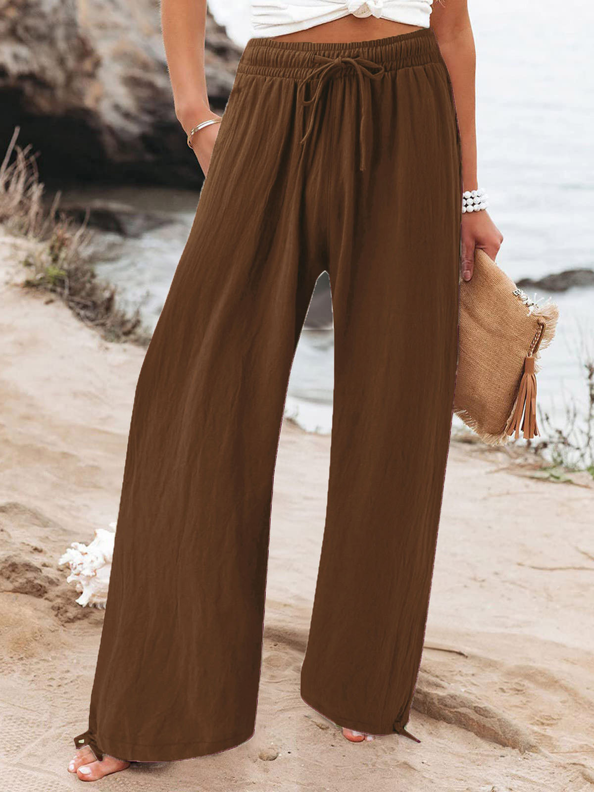 Plus size full length drawstring wide-leg pants by Trendsi, shown in a natural pose highlighting the relaxed fit and flowy fabric.