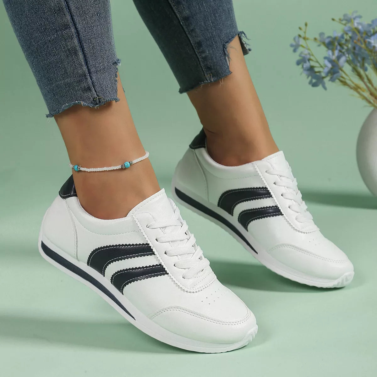Women’s round toe lace-up sneakers from Trendsi featuring a stylish design, white laces, and a comfortable rubber sole.