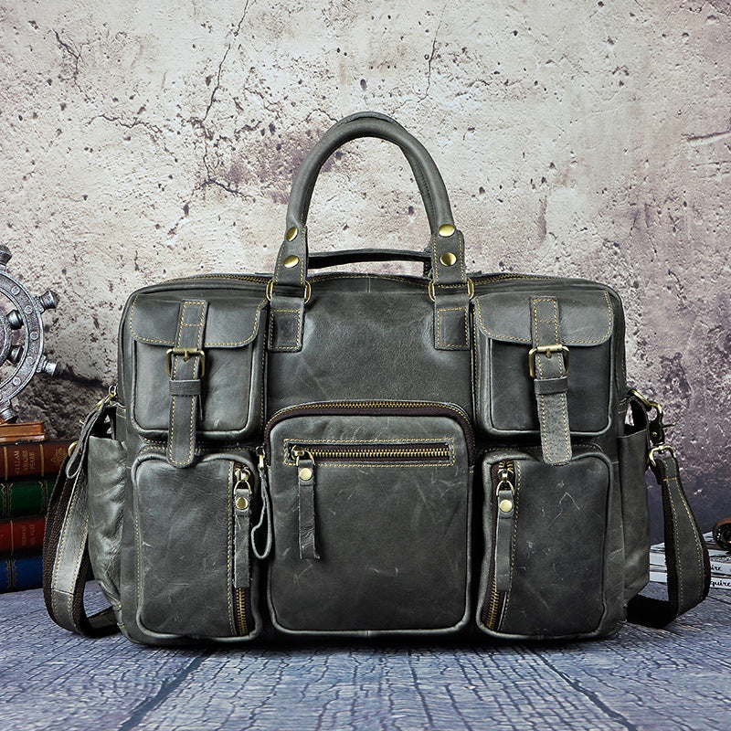 Pi-Mart men's first layer cowhide 16-inch large-capacity briefcase with sturdy handles and multiple compartments.