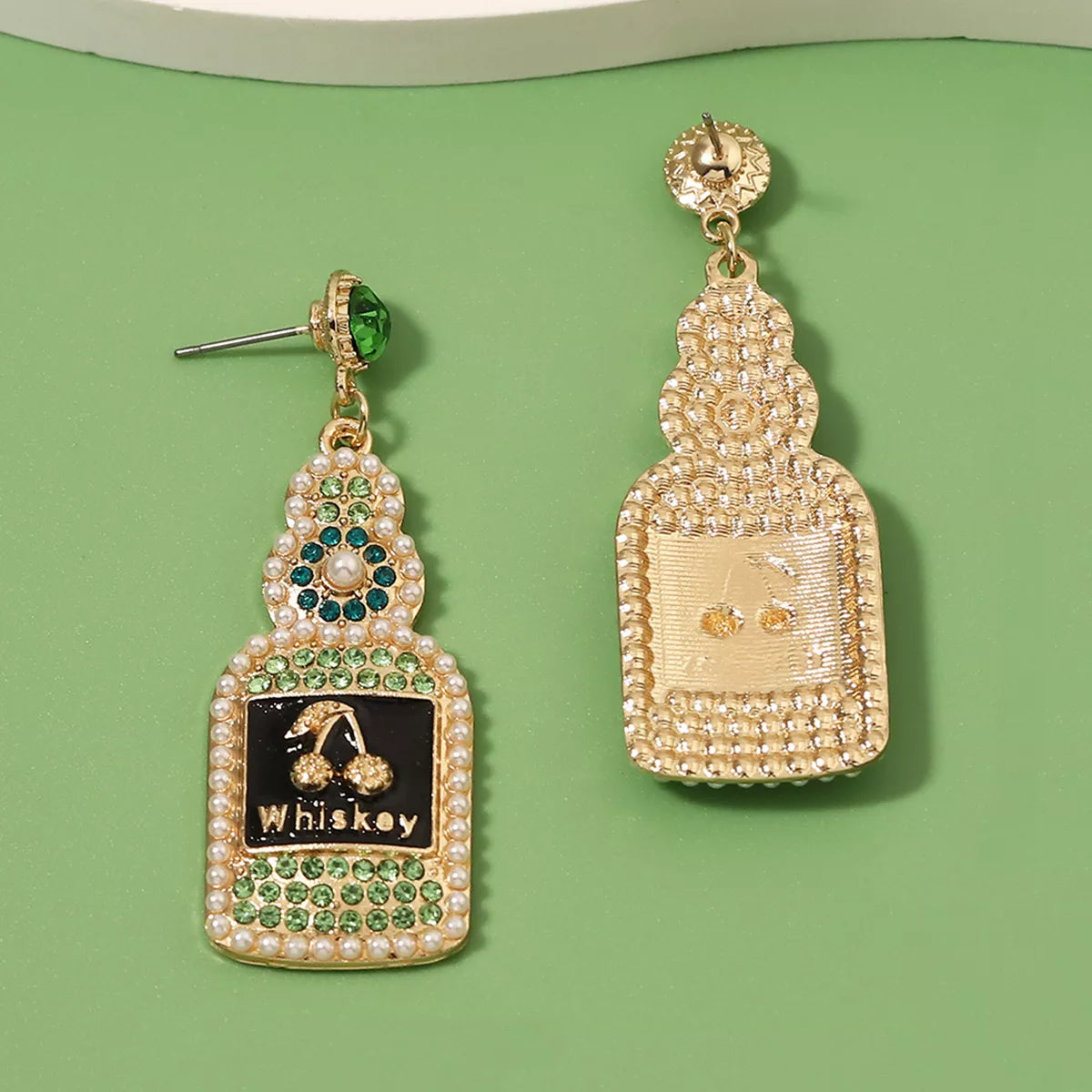 Whiskey bottle dangle earrings by Plush Fashion Hub featuring stylish metallic design, perfect for fashionable accessories.