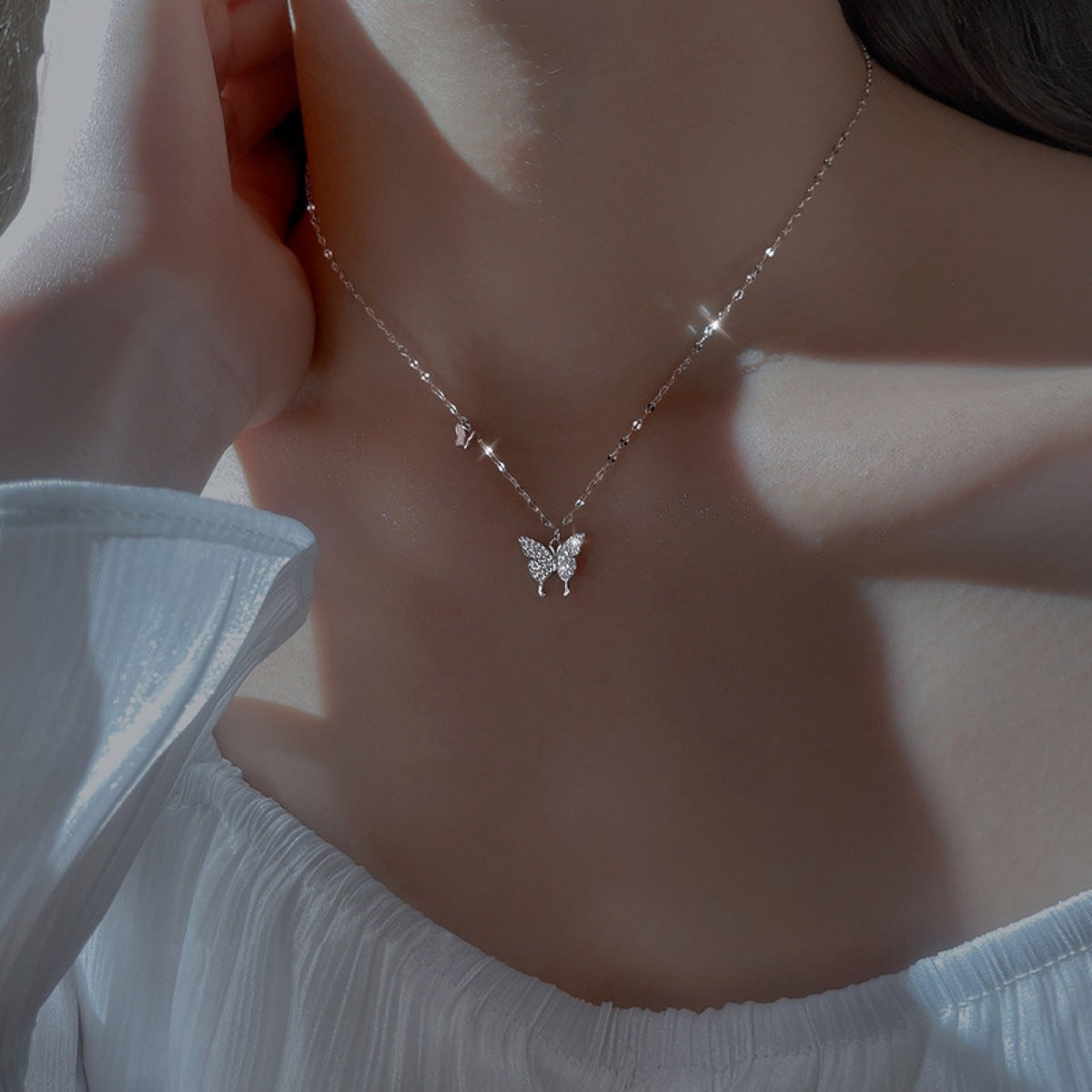 Sterling silver butterfly necklace with zircon accents, featuring a delicate design and chain, from Plush Fashion Hub.