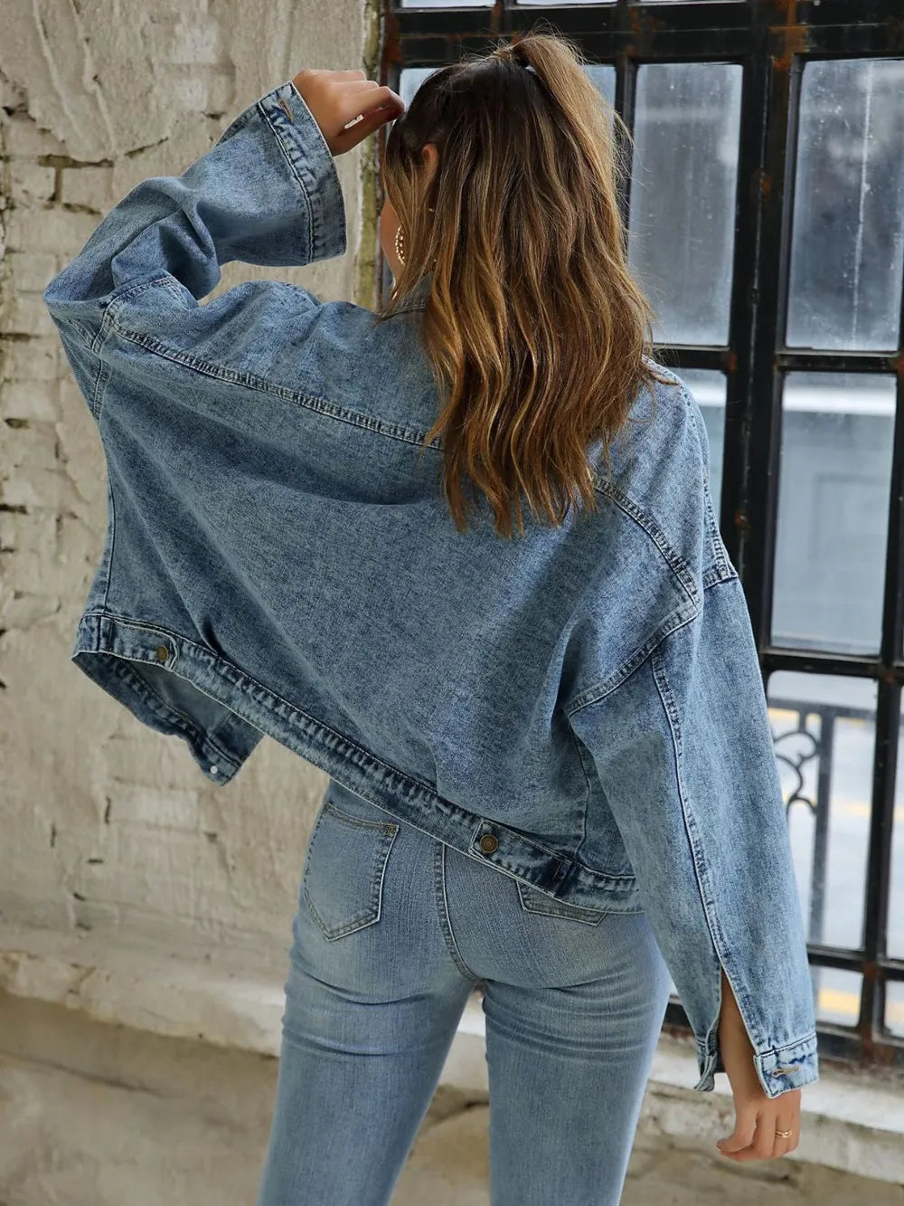 Blue denim jacket with drop shoulder design and button-down front, styled as trendy denim jeans from Trendsi.