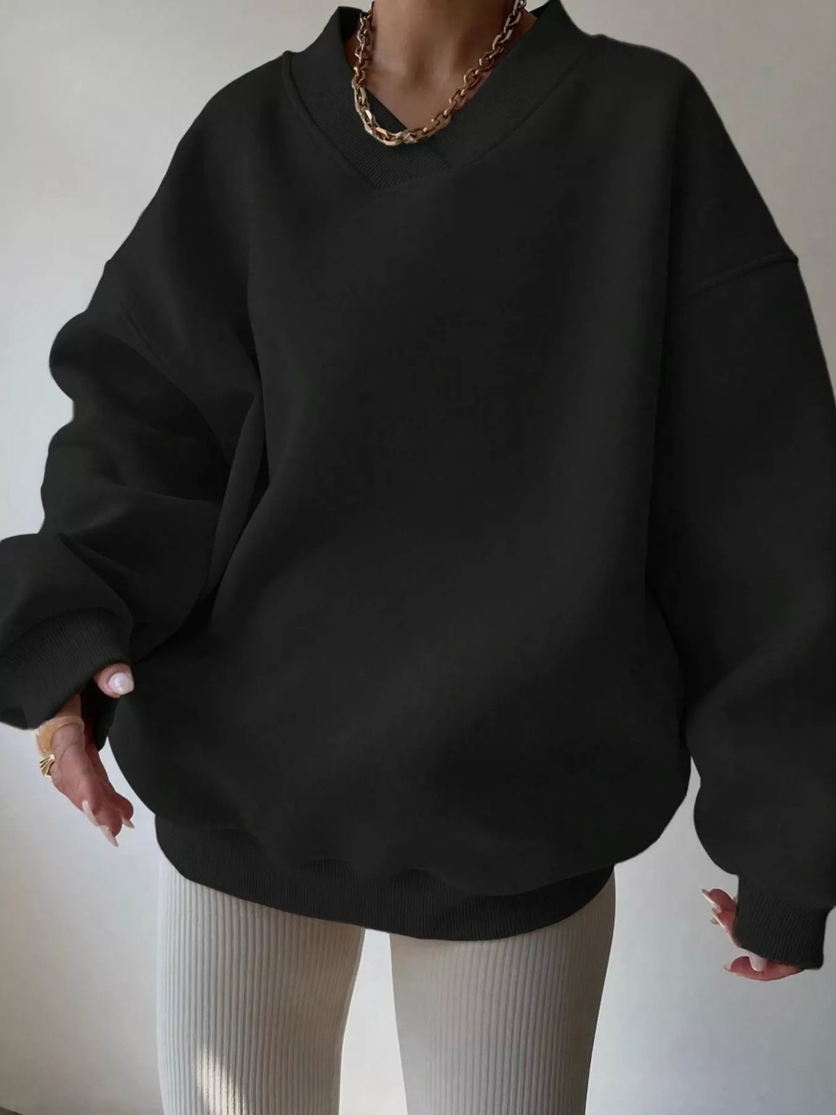 Oversized dropped shoulder long sleeve sweatshirt in soft fabric, featuring a relaxed fit and trendy design by Trendsi.
