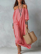 Women's striped loose-fit flared maxi dress by FitiqueFit, perfect for holidays and vacations, shown hanging on a wooden hanger.