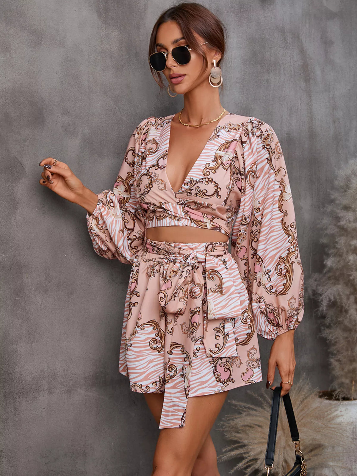Printed long sleeve romper with cutout front by Plush Fashion Hub, stylish jumpsuit perfect for casual or chic looks.