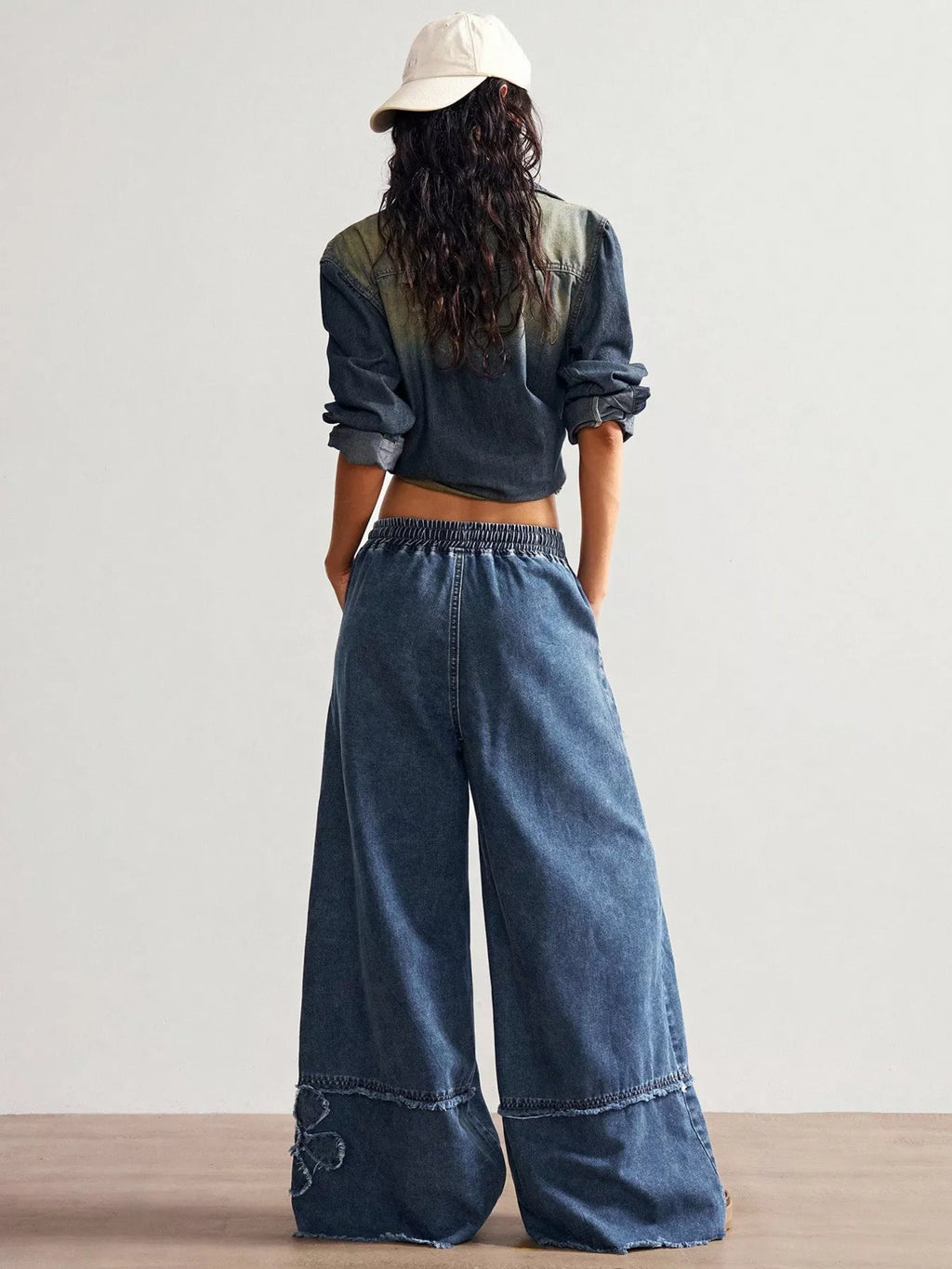 Wide leg jeans by Shopimist with floral appliques, featuring a relaxed fit and decorative floral embroidery details.