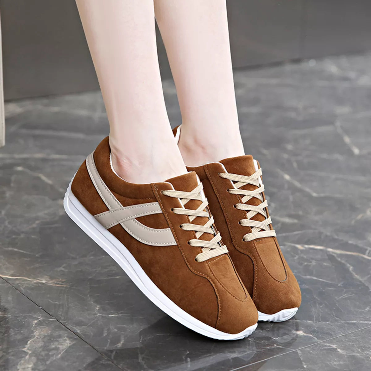 Women’s round toe lace-up sneakers by Trendsi, featuring a stylish design with white laces and a comfortable rubber sole.