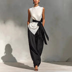 White women's lace-up sleeveless top and wide-leg pants two-piece casualwear set by FitiqueFit, shown on a model.