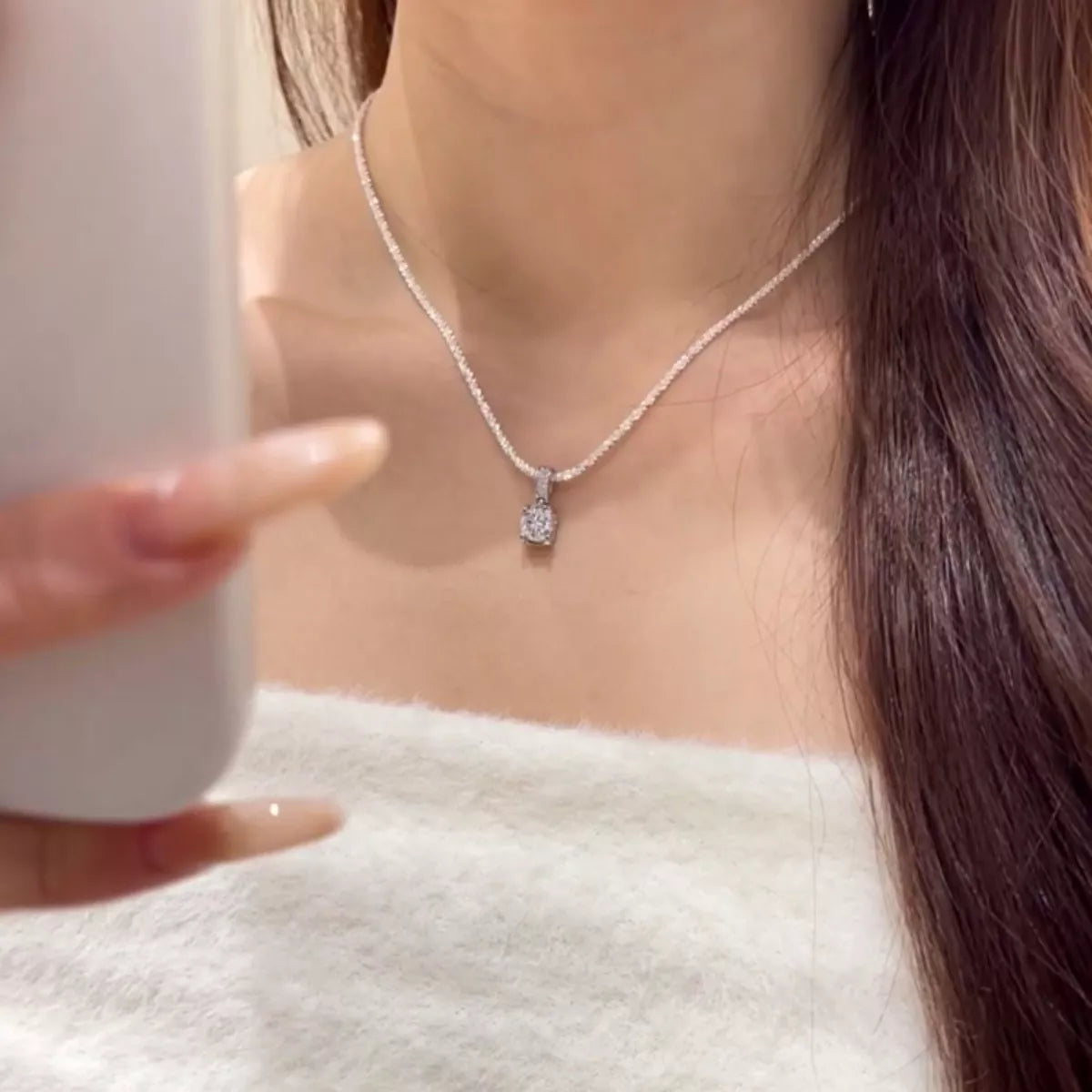 Sterling silver moissanite necklace with a 1-carat sparkling gemstone, elegant jewelry piece with a delicate chain.