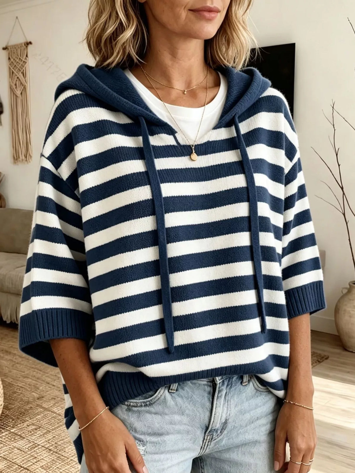 Plus size striped hooded sweater with drawstring, casual full-length sweater by Trendsi, featuring bold horizontal stripes and a relaxed fit.