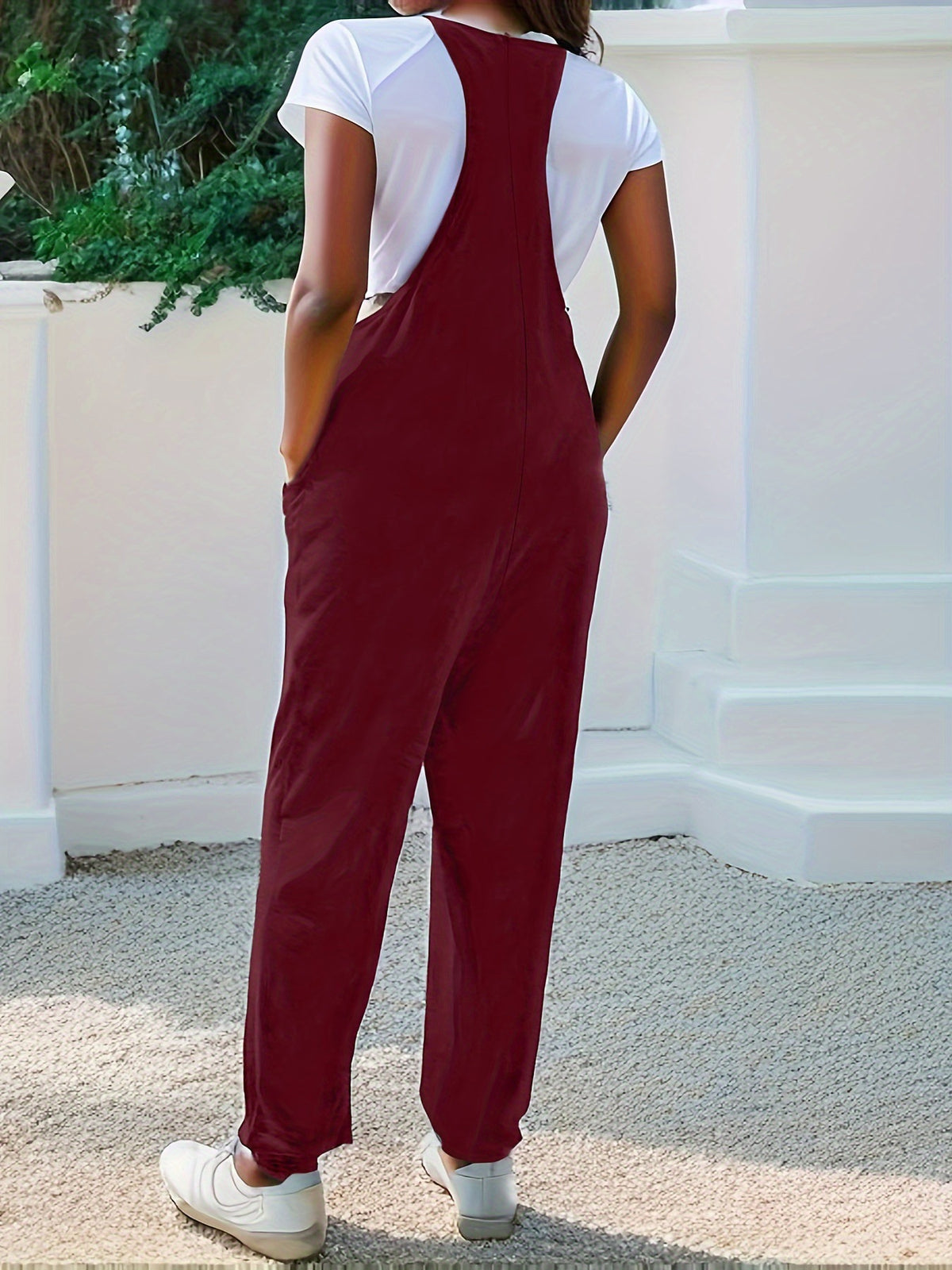 Casual loose fit spaghetti strap jumpsuit with pockets by Plush Fashion Hub, featuring a relaxed style and comfortable fit.