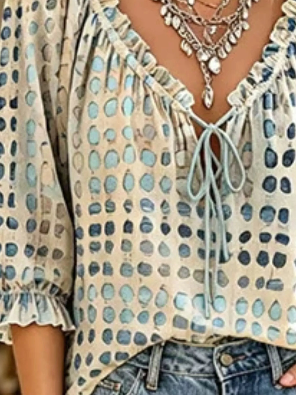 Plus size tie neck blouse with 3/4 sleeves from Trendsi, shown in a full-size image highlighting the collar and sleeve details.