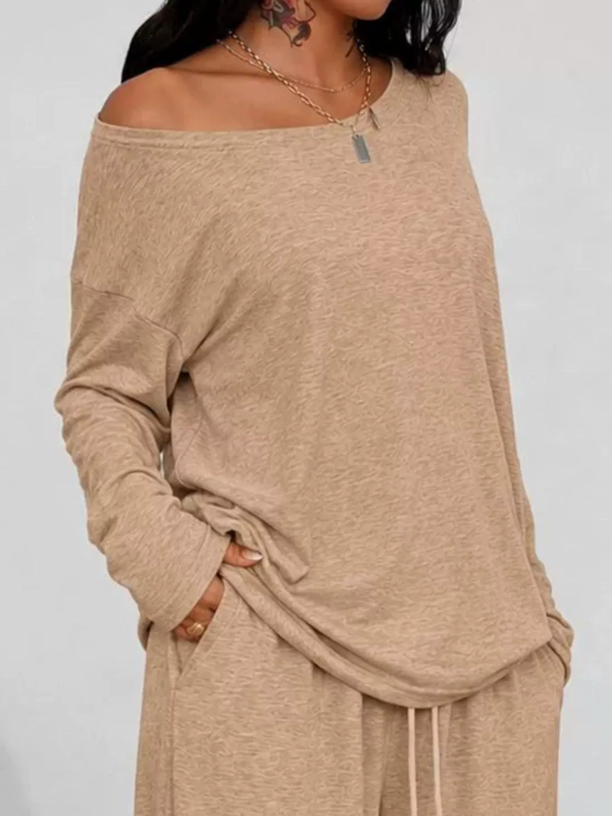Plus size loose fit one-shoulder T-shirt and pants matching set by Trendsi, featuring a relaxed, stylish design in the image.