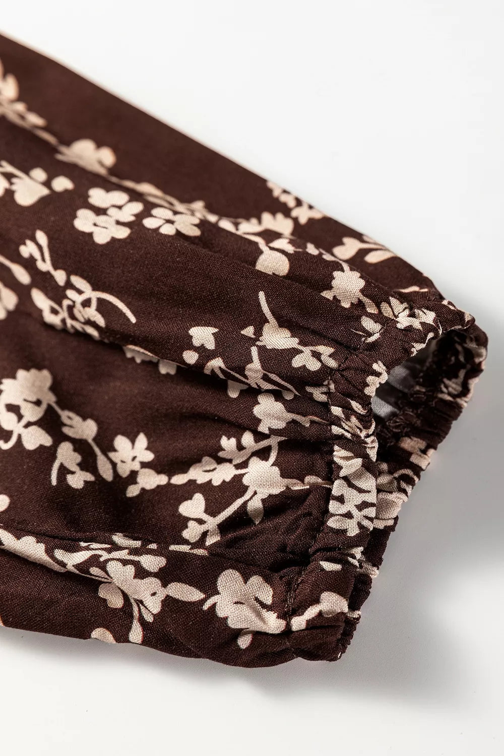 Ditsy floral print plush fashion hub mini dress with split neck, long sleeves, shirred waist, and flared hem.