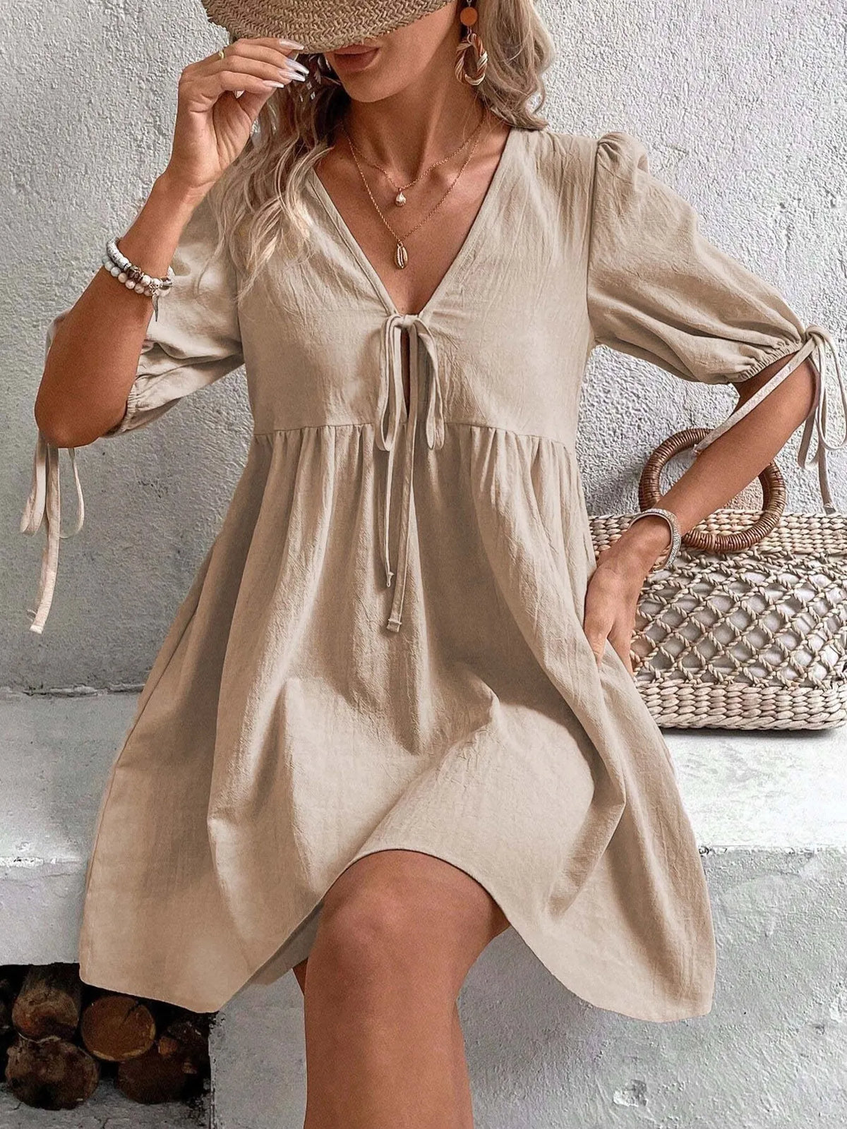 Cotton V-neck tie-front mini dress with puff sleeves by Plush Fashion Hub, shown in a stylish and casual design.