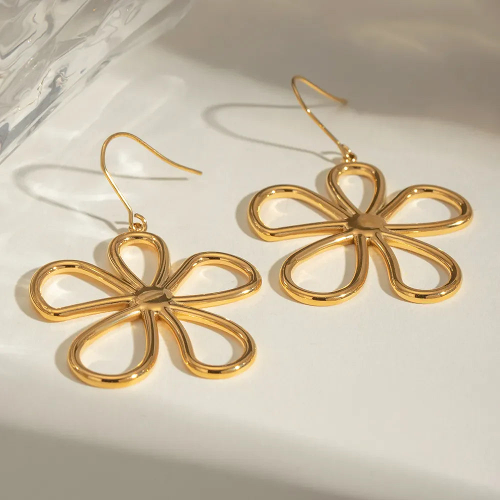 Gold-plated flower earrings with intricate petal design, showcasing elegant jewelry style from Plush Fashion Hub.