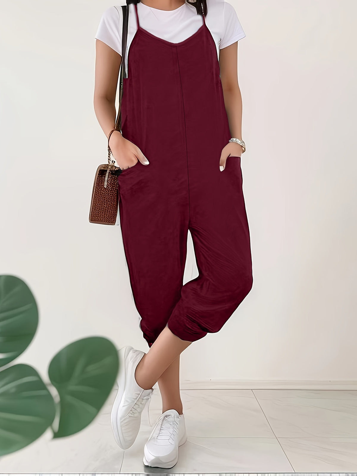 Casual loose fit spaghetti strap jumpsuit with pockets from Plush Fashion Hub, shown in a relaxed, stylish design.