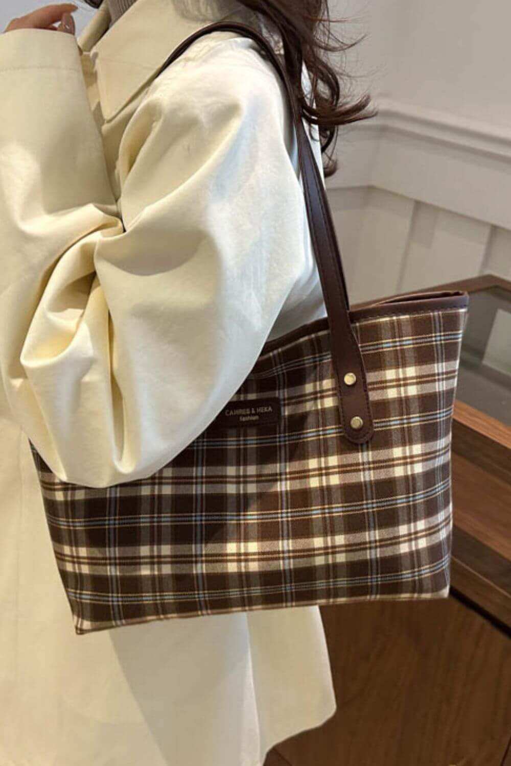 Plaid leather tote bag for women with brown and white checkered design.