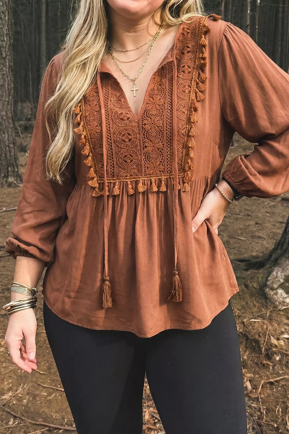 Plus size V-neck embroidered tassel long sleeve blouse from Trendsi, featuring intricate embroidery and flowing fabric.