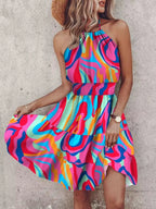 Paisley print halter neck mini dress by Plush Fashion Hub, featuring a fitted bodice and flowing skirt in vibrant fabric.